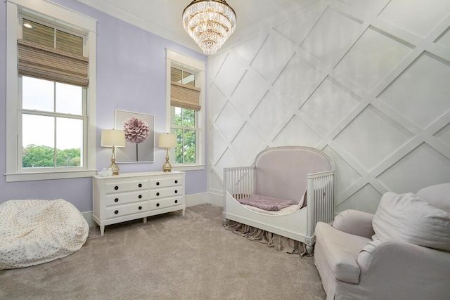 sitting room with a chandelier, a healthy amount of sunlight, and light colored carpet