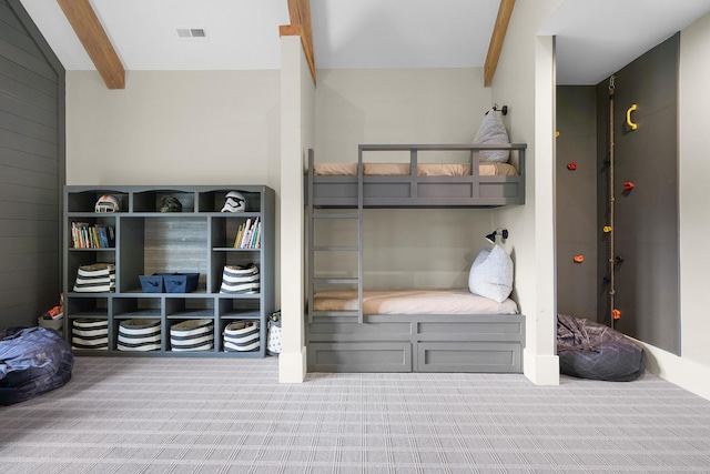 mudroom featuring carpet flooring and lofted ceiling with beams