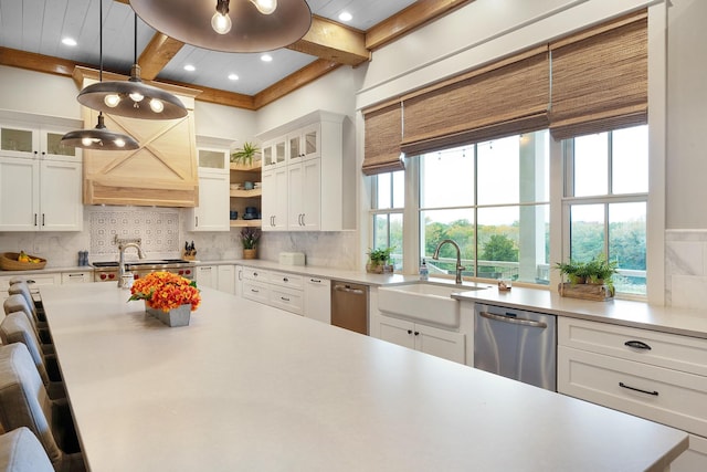 kitchen featuring dishwasher, beamed ceiling, sink, white cabinets, and tasteful backsplash