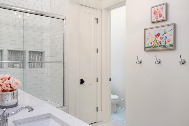 bathroom featuring toilet, an enclosed shower, tile patterned floors, and sink