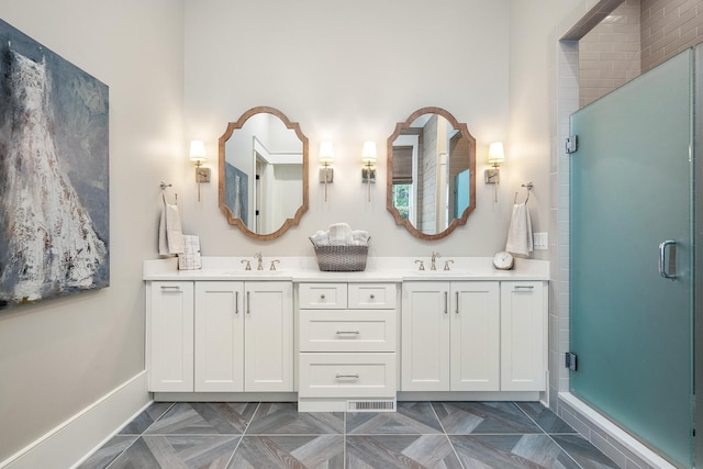 bathroom with a shower with door and vanity