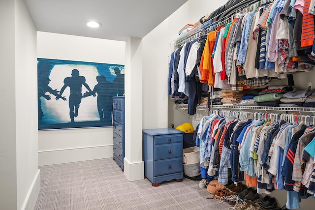 spacious closet featuring light carpet