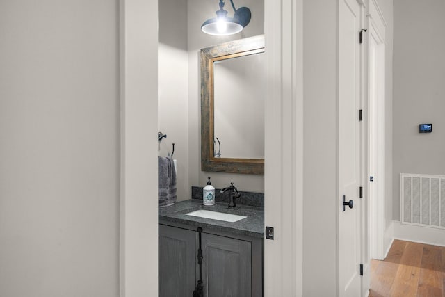 bathroom with hardwood / wood-style floors and vanity