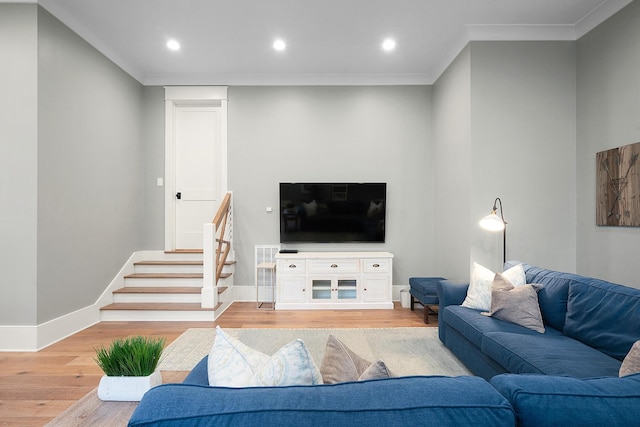 living room with ornamental molding and wood-type flooring