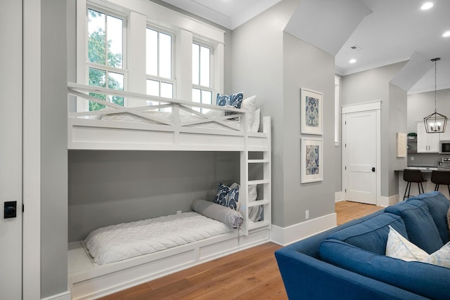 bedroom featuring an inviting chandelier and hardwood / wood-style flooring