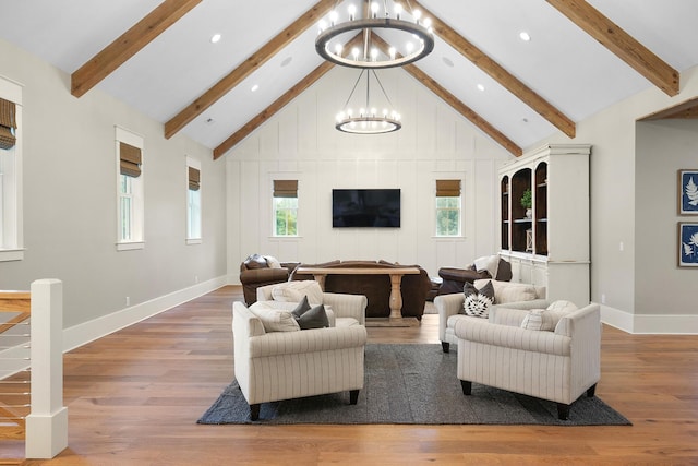 living room with beamed ceiling, high vaulted ceiling, a chandelier, and hardwood / wood-style flooring