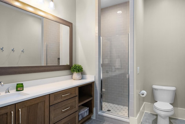 bathroom with toilet, walk in shower, and vanity