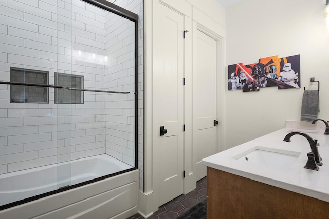 bathroom featuring tile patterned flooring, vanity, and combined bath / shower with glass door