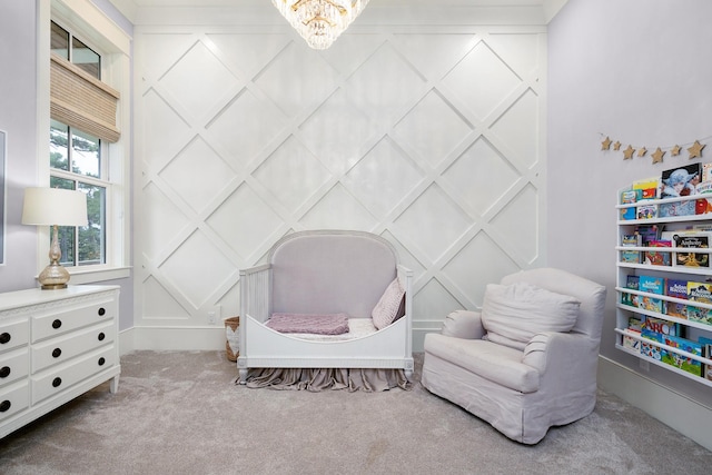 living area featuring a chandelier and carpet