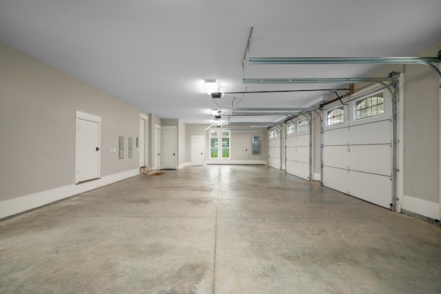 garage with electric panel and a garage door opener