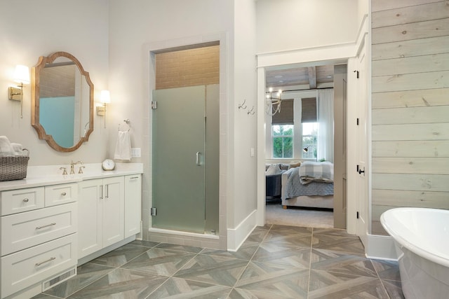 bathroom with separate shower and tub and vanity