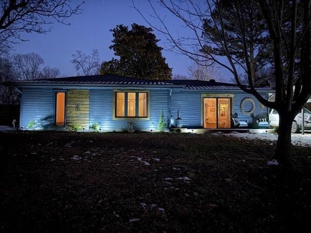 view of back house at dusk