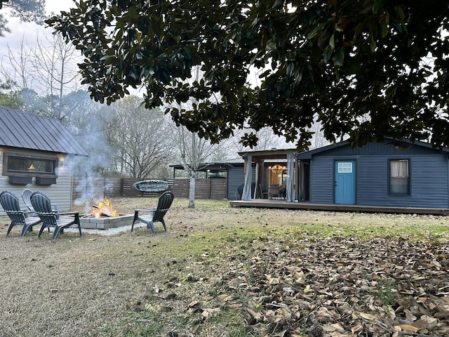 view of yard with a fire pit and an outdoor structure