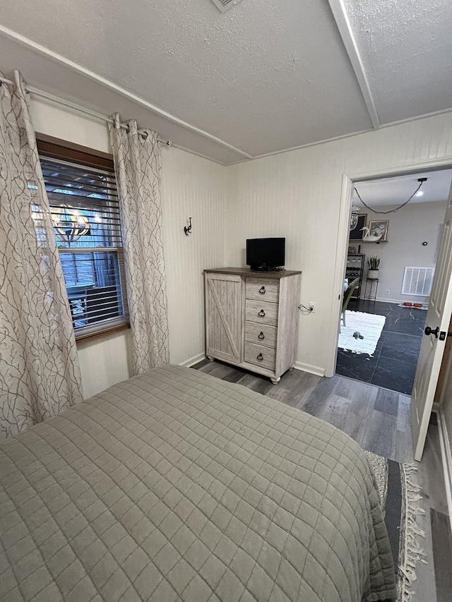 unfurnished bedroom featuring a textured ceiling and dark wood-type flooring