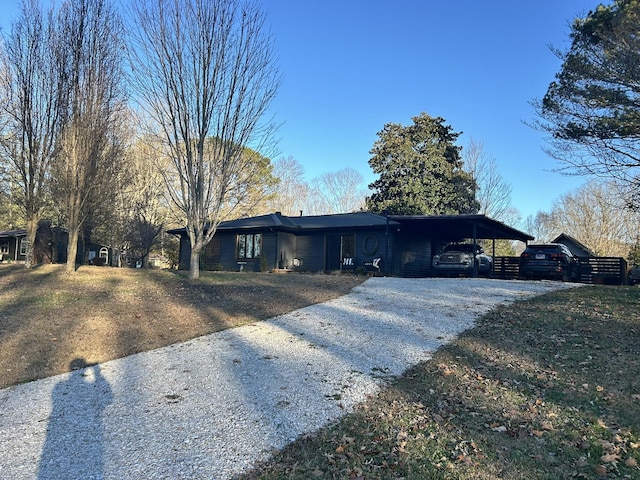 ranch-style house with a front yard and a carport