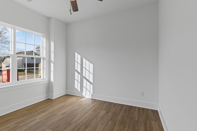 spare room with hardwood / wood-style flooring, a wealth of natural light, and ceiling fan