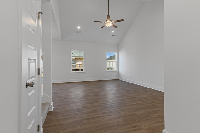 unfurnished living room featuring high vaulted ceiling, dark wood-type flooring, and ceiling fan