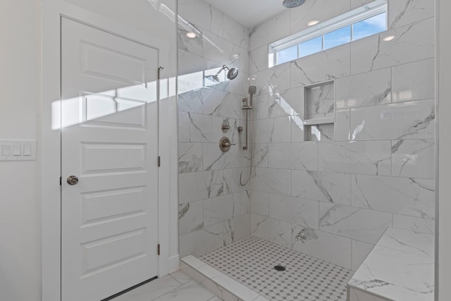 bathroom with a tile shower