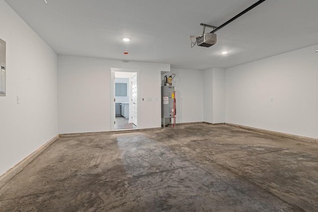 garage with water heater and a garage door opener