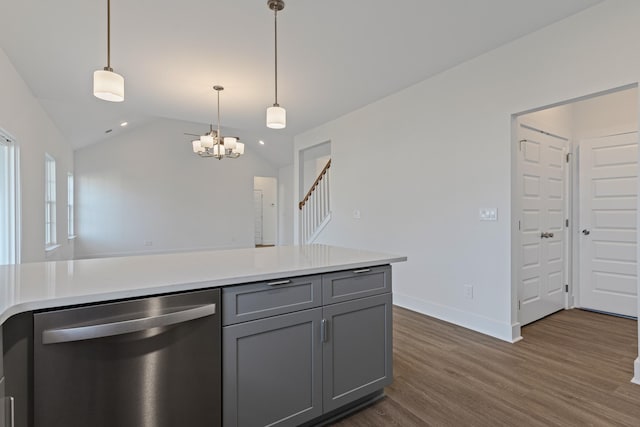 kitchen with gray cabinetry, dark hardwood / wood-style floors, dishwasher, vaulted ceiling, and pendant lighting