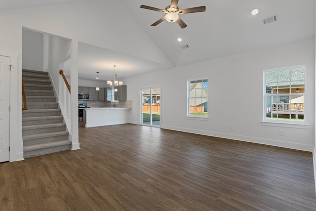 unfurnished living room featuring dark hardwood / wood-style flooring, sink, ceiling fan with notable chandelier, and high vaulted ceiling