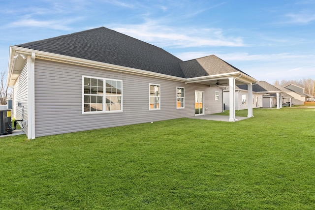 back of property featuring ceiling fan, a yard, central AC unit, and a patio