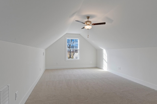 bonus room with light carpet, ceiling fan, and lofted ceiling