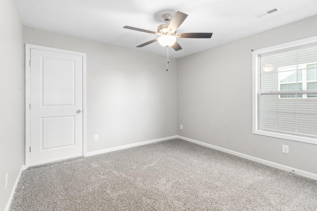 empty room with ceiling fan and carpet flooring