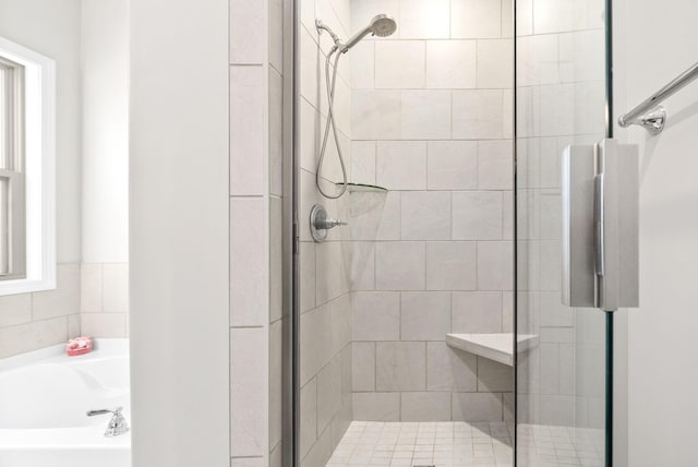 bathroom featuring separate shower and tub