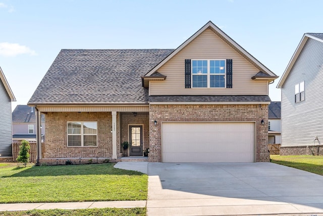 front of property featuring covered porch, a front yard, and a garage