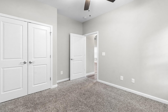 unfurnished bedroom with a closet, ceiling fan, and carpet floors