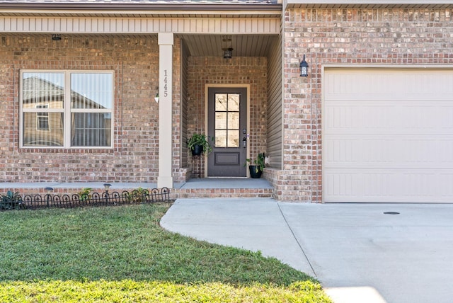 doorway to property featuring a yard and a garage