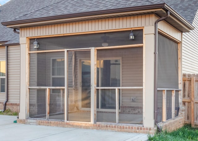 rear view of property with a sunroom