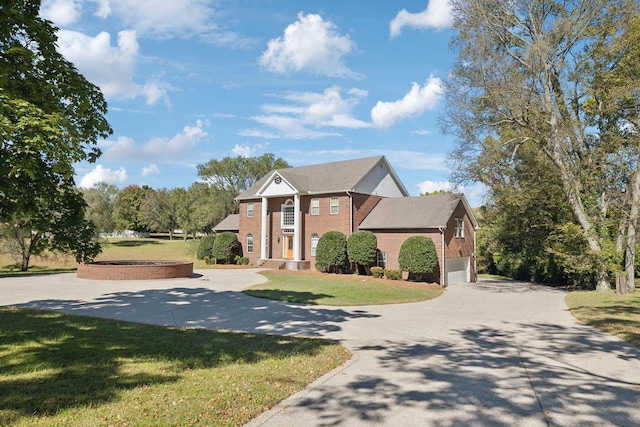 view of front facade featuring a front yard and a garage