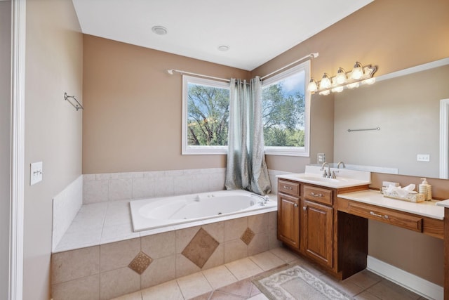 bathroom with vanity, tile patterned flooring, and tiled bath