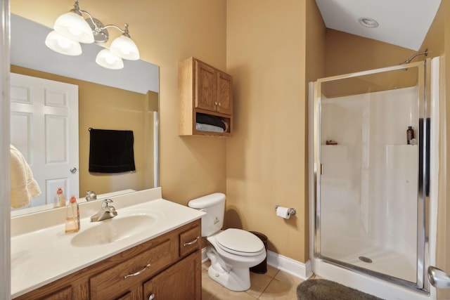 bathroom with vanity, tile patterned flooring, toilet, and walk in shower