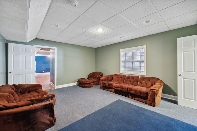 carpeted living room with a drop ceiling