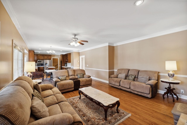 living room with light hardwood / wood-style flooring, crown molding, and ceiling fan with notable chandelier