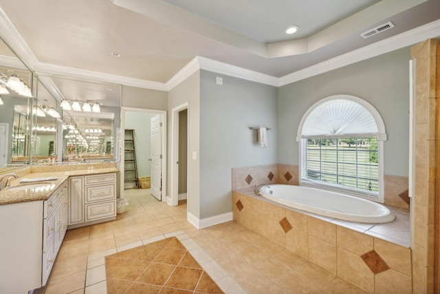 bathroom featuring vanity, tile patterned flooring, ornamental molding, and tiled tub