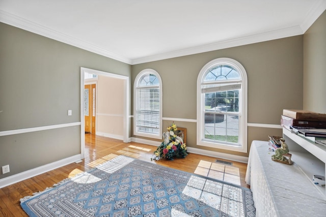 interior space with light wood-type flooring and ornamental molding