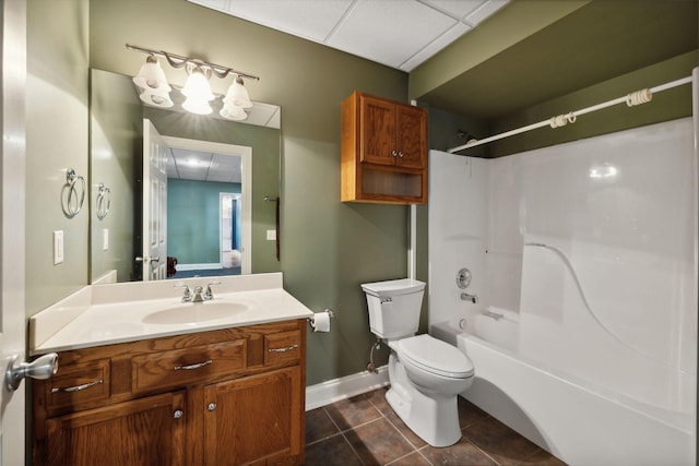 full bathroom featuring washtub / shower combination, a drop ceiling, vanity, and toilet