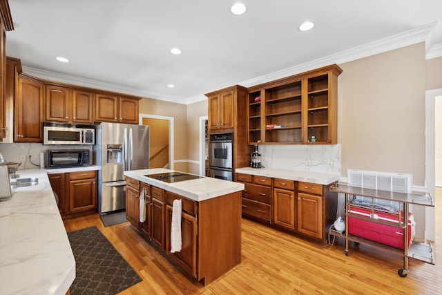 kitchen featuring black appliances, light hardwood / wood-style flooring, ornamental molding, and tasteful backsplash