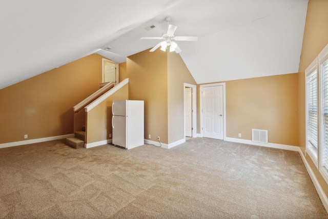 bonus room featuring lofted ceiling, ceiling fan, and light colored carpet