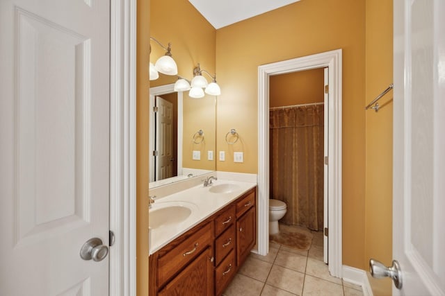 bathroom featuring toilet, tile patterned floors, and vanity