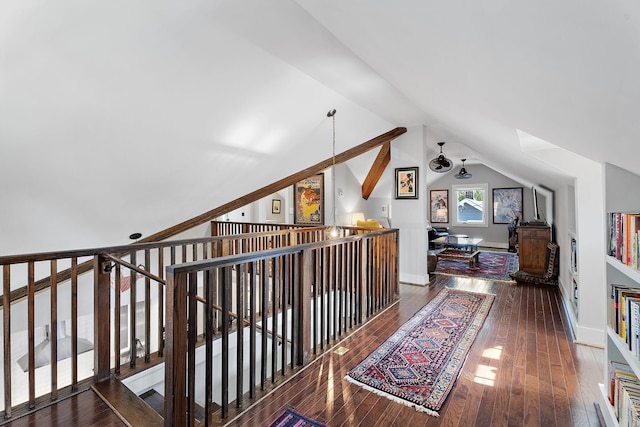 hallway featuring dark hardwood / wood-style flooring and lofted ceiling