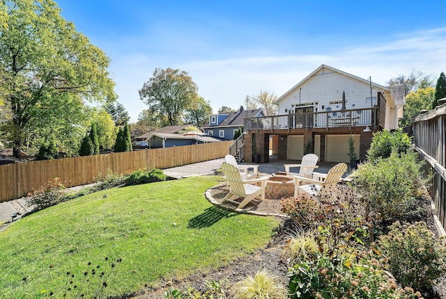 view of yard with a wooden deck, an outdoor fire pit, and a patio area