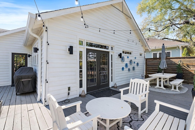 deck with french doors and a grill