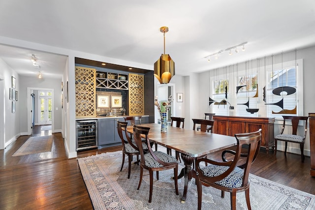 dining area with indoor bar, dark hardwood / wood-style floors, and wine cooler