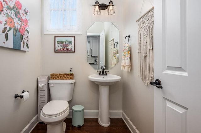 bathroom featuring toilet, sink, and hardwood / wood-style flooring