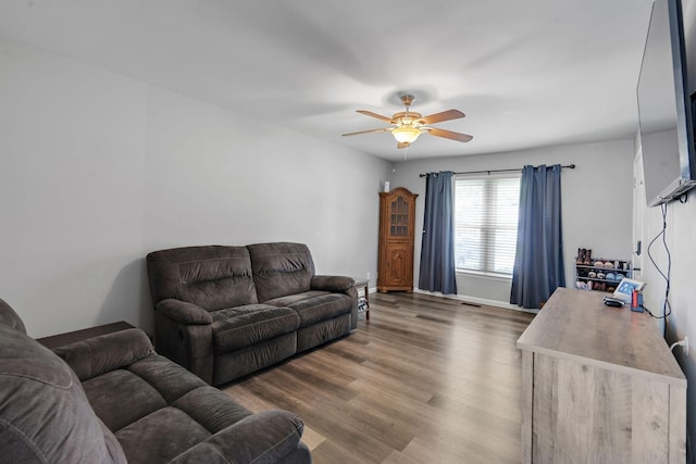 living room featuring ceiling fan and hardwood / wood-style floors